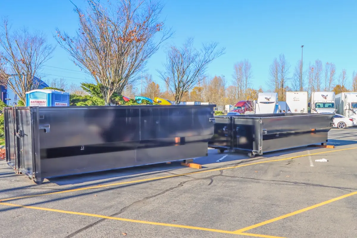 Professional dumpster rental service with roll-off container on residential driveway in Ahuimanu